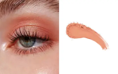 Delikatny makijaż oka w odcieniach brzoskwini, z subtelnym połyskiem. Obok próbka pudrowego różu, niczym delikatny **peach fuzz**.